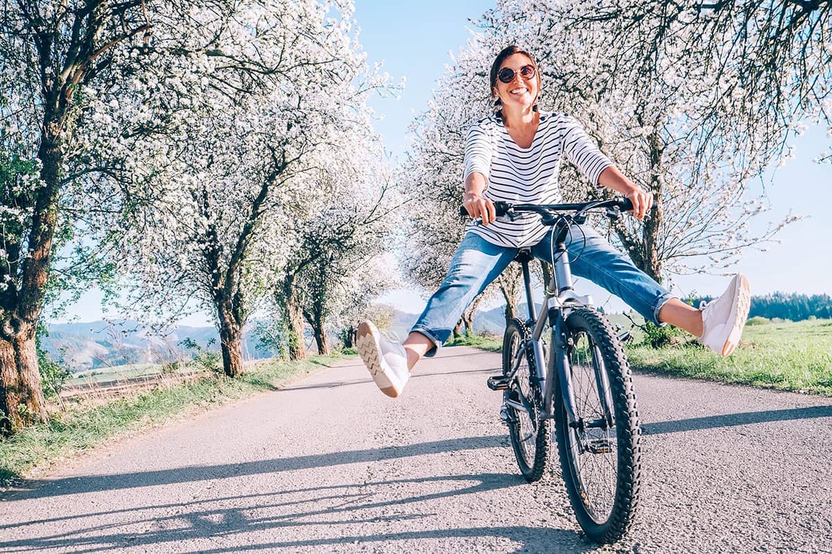 woman laughing while riding a bike