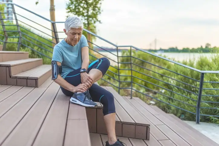 Woman Holding Ankle