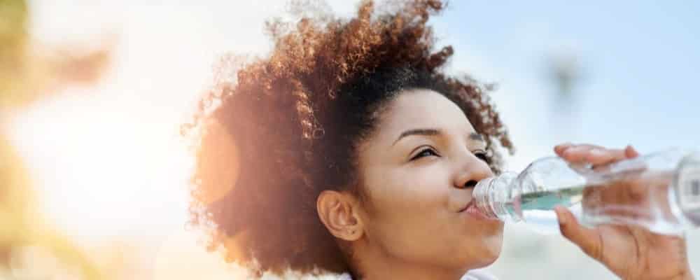 Woman Drinking Water Outside