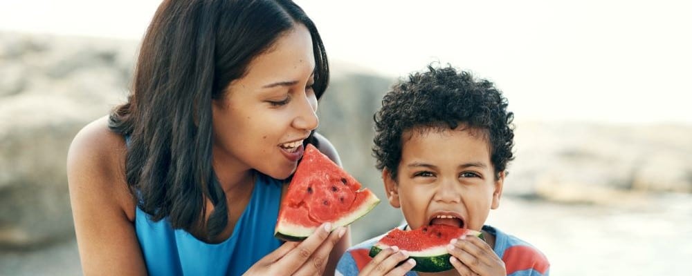 Mom and Son Eating Watermelon Outside