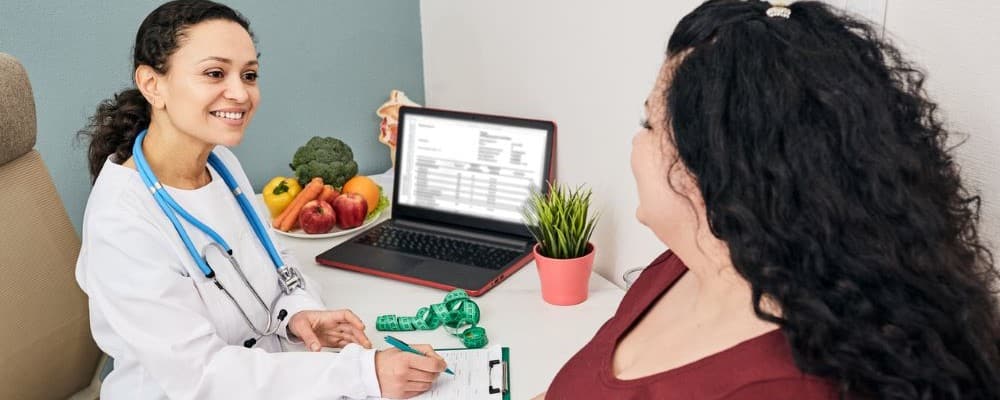 Female Dietitian Speaking With Patient