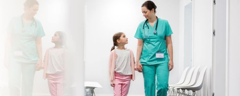 Nurse Walking With Young Girl