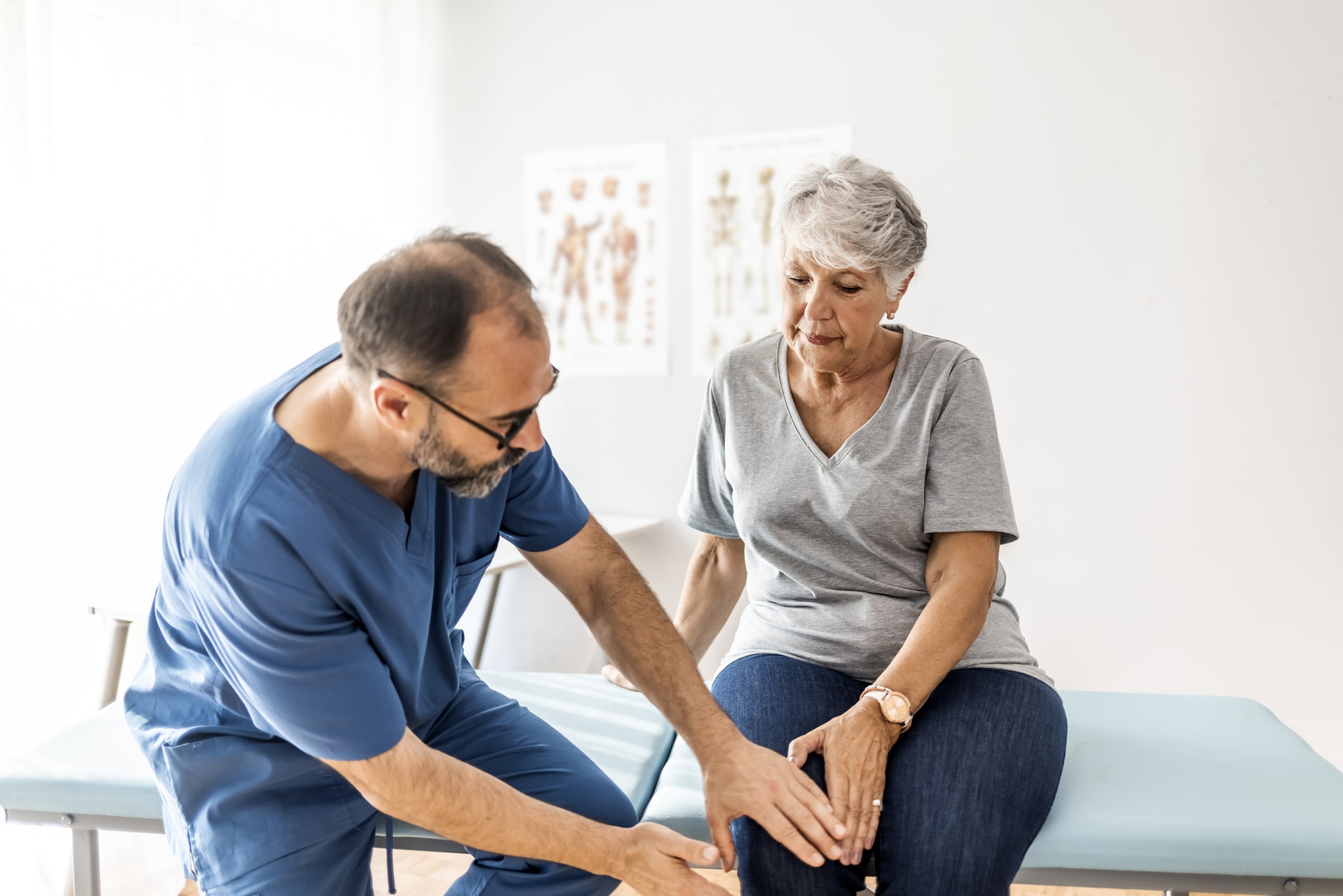 Senior woman having her knee examined by a doctor.