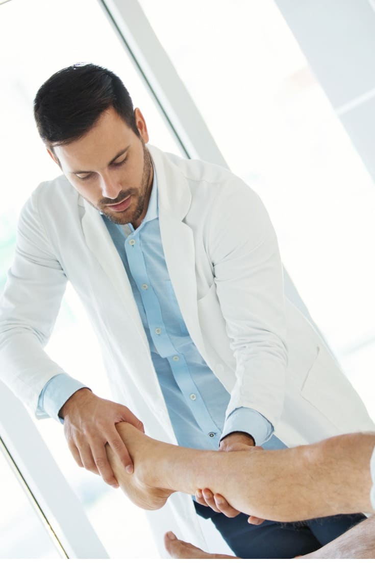 male doctor conducting a foot pain and disorder diagnosis