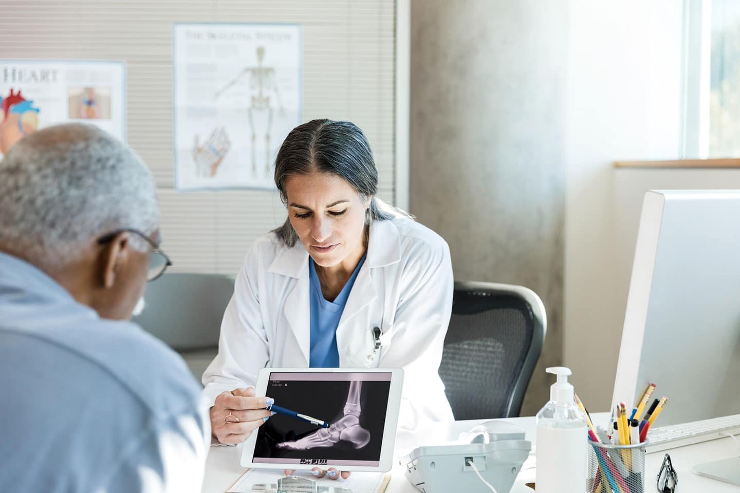 Female doctor explaining x-ray results to male patient